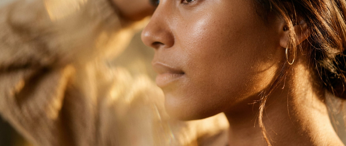 Closeup of smooth healthy skin in warm golden side light — fine lines
