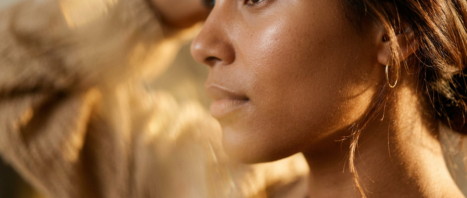 Closeup of smooth healthy skin in warm golden side light — fine lines
