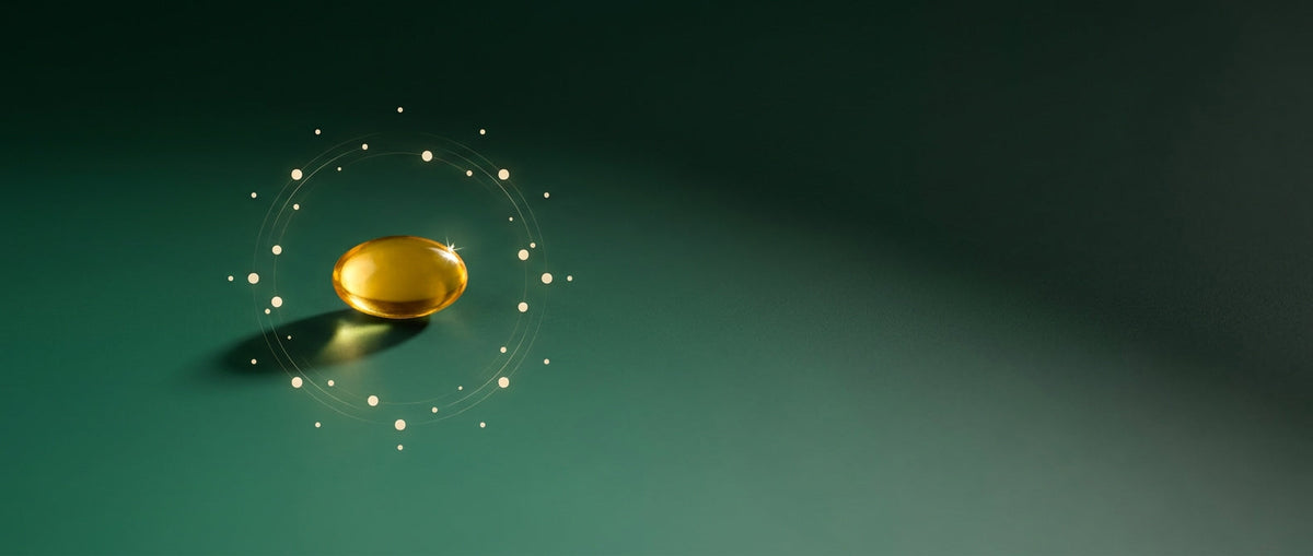 Nutrafol gold capsule on emerald background — hair wellness from within